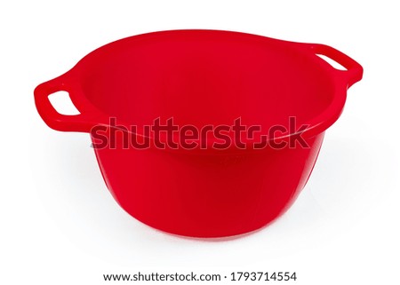 Red plastic round household basin with handles on a white background
