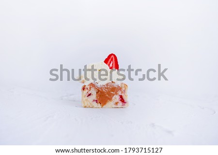 Strawberry cupcake cut with caramel filling inside on a white background, isolated background image