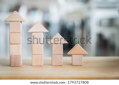 Wooden house model on  wood background, a symbol for construction , ecology, loan, mortgage, property or home.