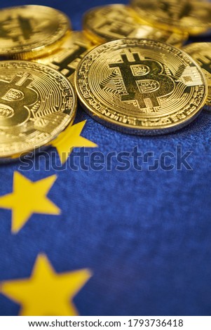 coins Bitcoin,  European flag, the concept of virtual money, close-up. Conceptual image of digital crypto currency.