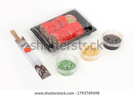 California rolls, covered by red caviar delivered in container