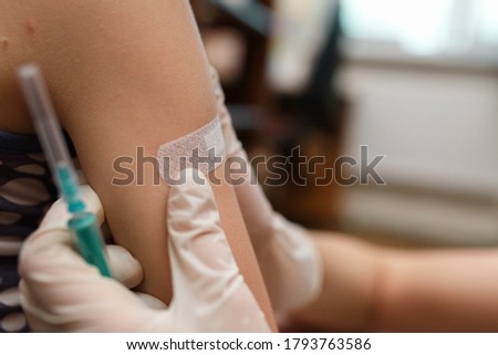 Little girl with band aid on the shoulder from the injection. Vaccinated in the arm. Prevention of children diseases through vaccination. Health care and medicine concept. Focus on shoulder. Royalty-Free Stock Photo #1793763586