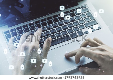Creative concept of abstract medical illustration and hands typing on laptop on background. Medicine and healthcare concept. Multiexposure