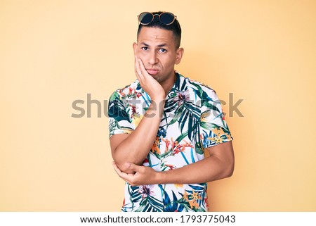 Young handsome latin man wearing summer clothes thinking looking tired and bored with depression problems with crossed arms. 