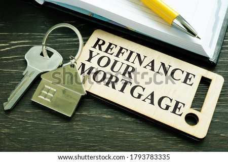 Refinance your mortgage phrase and key with small home. Royalty-Free Stock Photo #1793783335