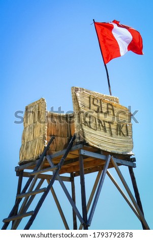 Watchtower and flag of the floating Uros island Isla Kontiki, Titicaca lake, Peru, South America