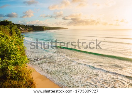Coastline with beach, waves for surfing and warn sunlight in Bali