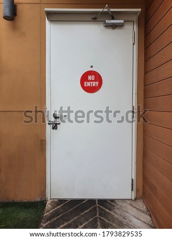 Old white door with no entry sign