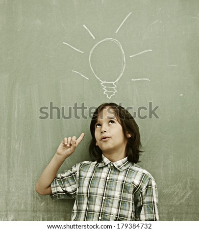 Cheerful kids at school room having education activity on chalkboard