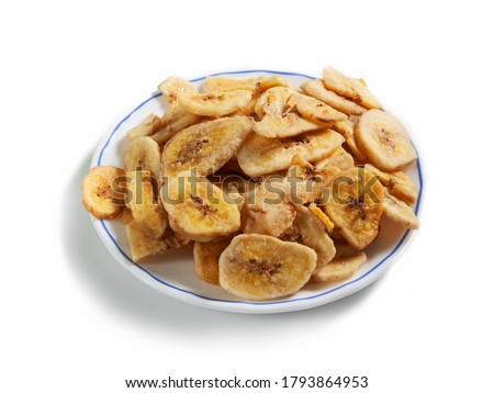 cut dried banana on a white saucer with a blue border isolated on a white background