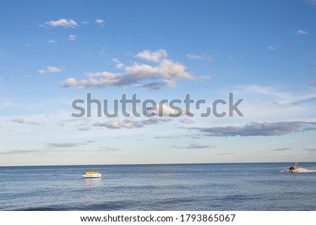 Azure ocean and blue sky with clouds, beach background.