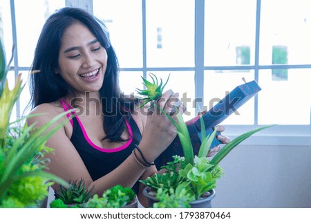 Asian women, beautiful girls, hobby, planting trees to purify the air in the house.
