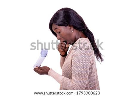 a beautiful woman standing on white background yawning while holding an envelope.