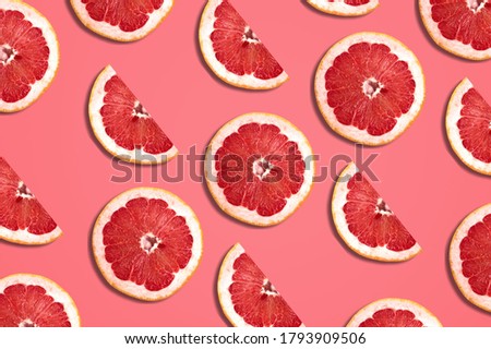 Fresh red orange or grapefruit slices on color background.