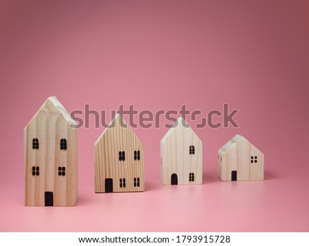 Mini residential craft house on a pink background.