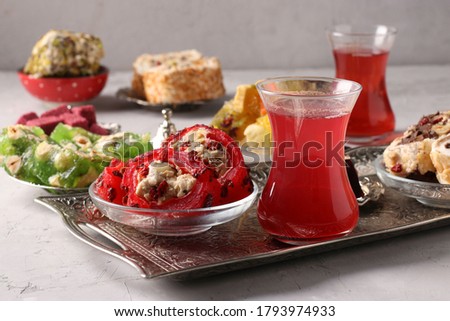 Turkish delight and pomegranate tea on metal tray on gray background, Horizontal format