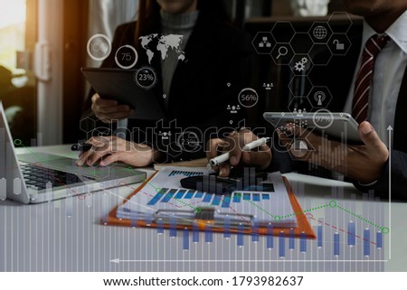 Double exposure of  business partners discussing documents and meeting at the modern office desk, Business financial virtual chart, Digital marketing concept, Background toned image blurred.