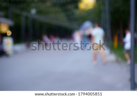 Blurred background. Recreation Park with people. Summer.