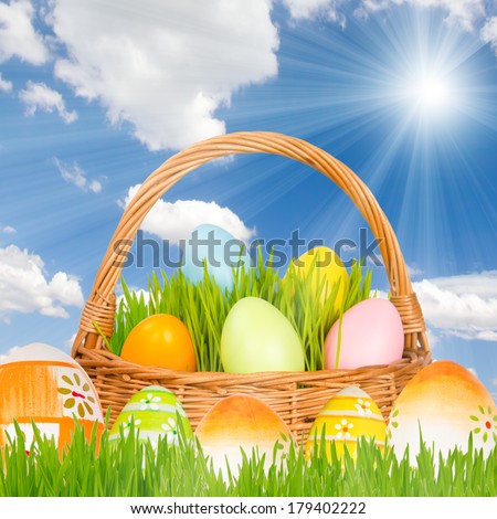 Basket with grass, sky and easter eggs