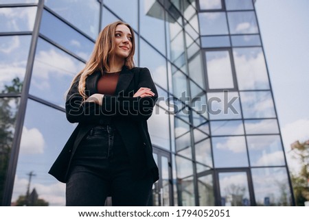 Young beautiful business woman by the office center