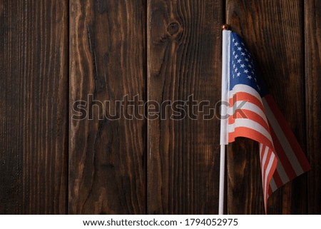 American flag on wooden background, space for text
