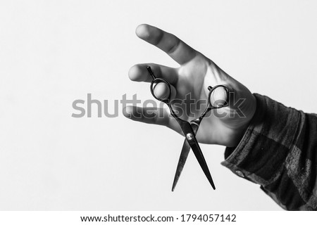 Barber shop. Barber hand holding scissors. Barber professional tools. Male haircut, fashion. Barbershop, haircut and shaving background. Small business. Background with copy space. Royalty-Free Stock Photo #1794057142
