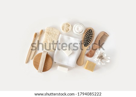 Zero waste concept. Set of eco friendly bathroom accessories on white background - natural soap, eco bag, bamboo toothbrush, natural hairbrush. Sustainable, eco-friendly lifestyle.