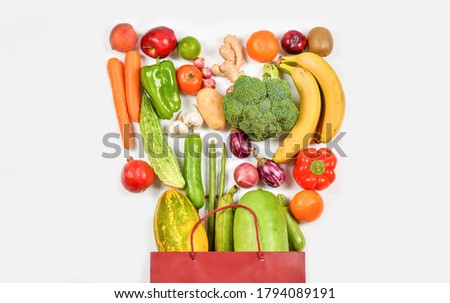 Fresh Fruits and Vegetables on White background, Healthy food background, Healthy vegan vegetarian food in paper bag, copy space, banner. Shopping food supermarket and clean vegan eating 