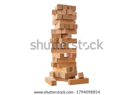 Board game Jenga Tower made of wooden blocks. A tower of unevenly shifted wooden beams. A lesson for agility, logic and coordination. Home entertainment. Balance. Close-up. Isolation, white background Royalty-Free Stock Photo #1794098854