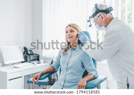 Middle aged female patient visiting doctor otolaryngologist Royalty-Free Stock Photo #1794118585