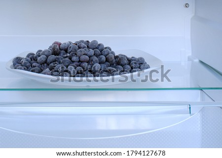 frozen blueberries in a plate in refrigerator