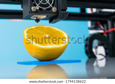 Ripe slice of yellow lemon citrus fruit . 3d printer of the device during the processe.