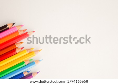 The cropped shot view of color pencils with white background, blank copy space screen for your text message or information content.
