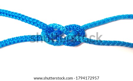 blue rope knot isolated on a white background as a strong nautical marine line tied together as a symbol for trust and faith ,infinity shape