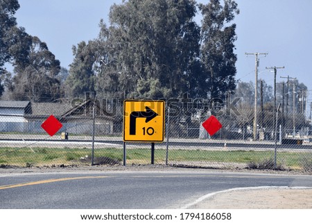 Slow right turn sign 10 miles an hour
