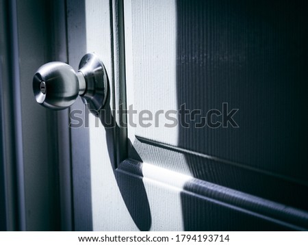 Side view of doorknob on door  home exterior architecture concept with shadow