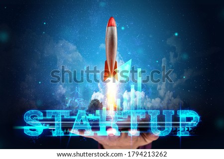 The inscription start-up, the rocket taking off on the background image of the development strategy charts, business concept, new technologies. Copy space