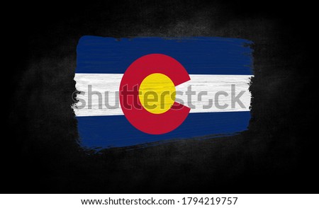 smear of paint in the form of the flag of State of Colorado close-up on a black background