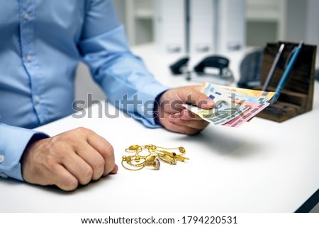Man buying gold jewellry, pawn shop and euro banknotes Royalty-Free Stock Photo #1794220531