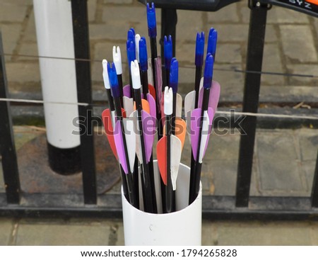 Bunch of darts in a white plastic bowl