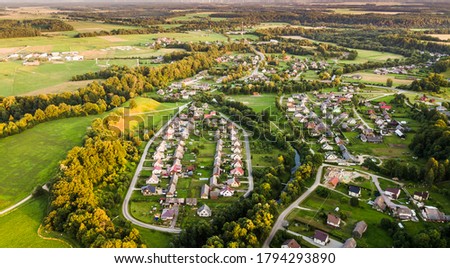 Aerial view of Pagramantis town in Lithuania and park with river curves during evening sunset in summer.