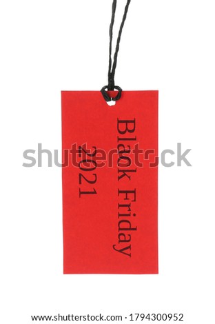 Red tag with words BLACK FRIDAY 2021 hanging on white background