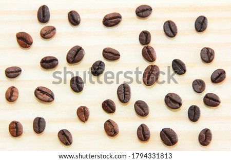 natural black coffee beans on wooden background