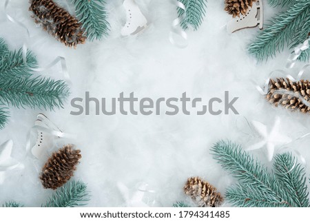 New Year's and Christmas layout of pine branches and decor in the snow with a copy space