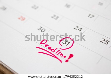 Deadline write on white calendar page date close up