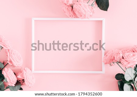 Beautiful flowers composition. Photo Frame, pink rose flowers on pastel pink background. Valentines Day, Easter, Birthday, Happy Women's Day, Mother's day. Flat lay, top view, copy space