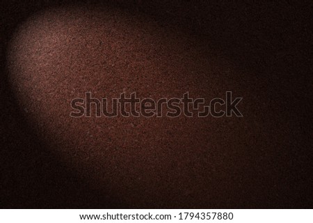 Abstract background of an active field texture athletics running track red-brown add light to the surface.