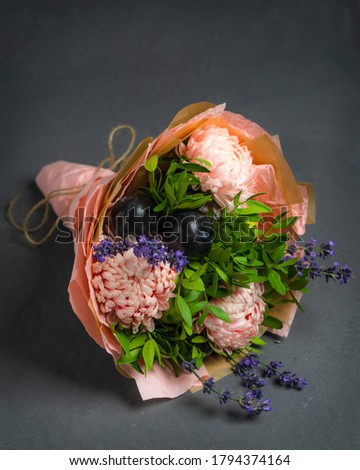Pink bouquet of plum and Astra pistachio and lavender on a gray background