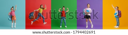 Back to school and happy time! Collage of five children on colorful paper wall background. Kids with backpack. Girls glad ready to study. Royalty-Free Stock Photo #1794402691