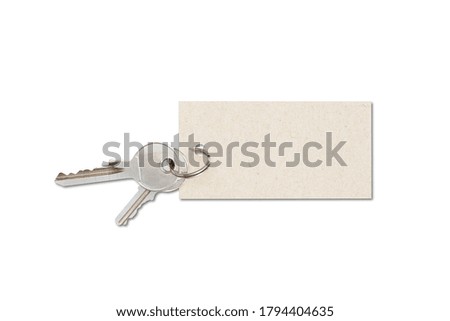 A close up shot of keys and an empty tag on a white background